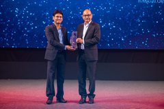 Dr. Pinaki Bhaskar on stage receiving the Zinnov Awards 2022 trophy